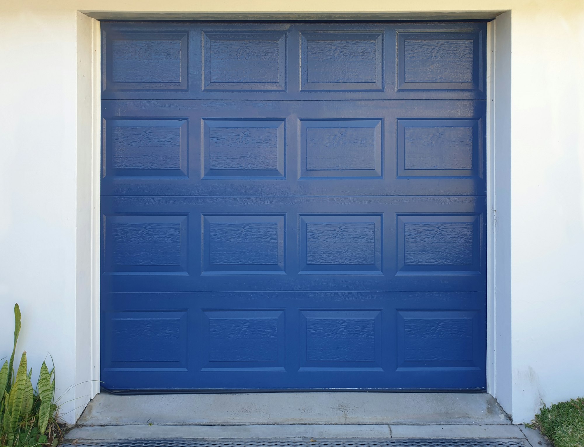 blue garage door against white wall